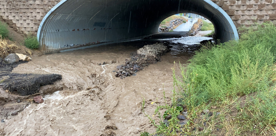 Midas Creek Trail overrun with the rising creek during a heavy rainstorm