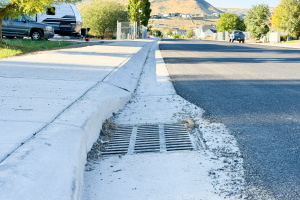 A close-up of a stormwater drain along the newly installed curb and gutter on 7300 West in Herriman.