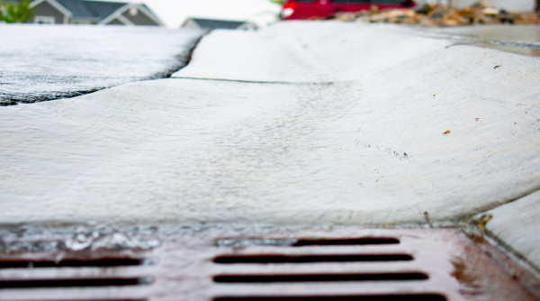 Water pours down a drain from a gutter during a June 2020 Herriman rainstorm.